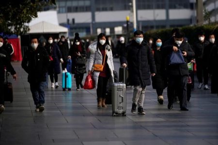 Passengers wearing masks walk at the Shanghai railway station in China, as the country is hit by an outbreak of the novel coronavirus, February 9, 2020. REUTERS/Aly Song/File Photo
