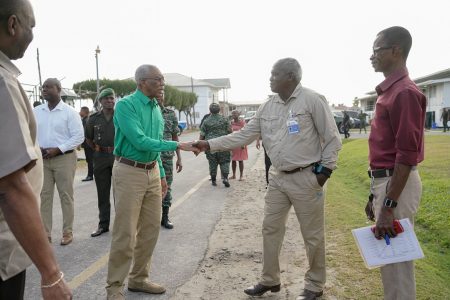 President David Granger greets PPP/C-nominated Elections Commissioner Robeson Benn during a visit to Camp Ayanganna. (APNU+AFC photo)
