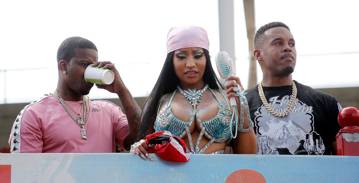 Hip hop artiste Nicki Minaj aboard a Tribe truck looks at masqueraders during the Parade of Bands at the Socadrome, Hasely Crawford Stadium, on Tuesday.