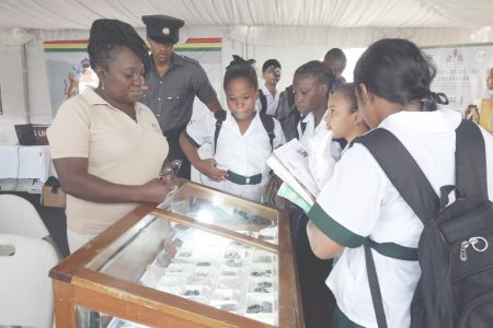 Students viewing precious stones on display at the GGMC booth