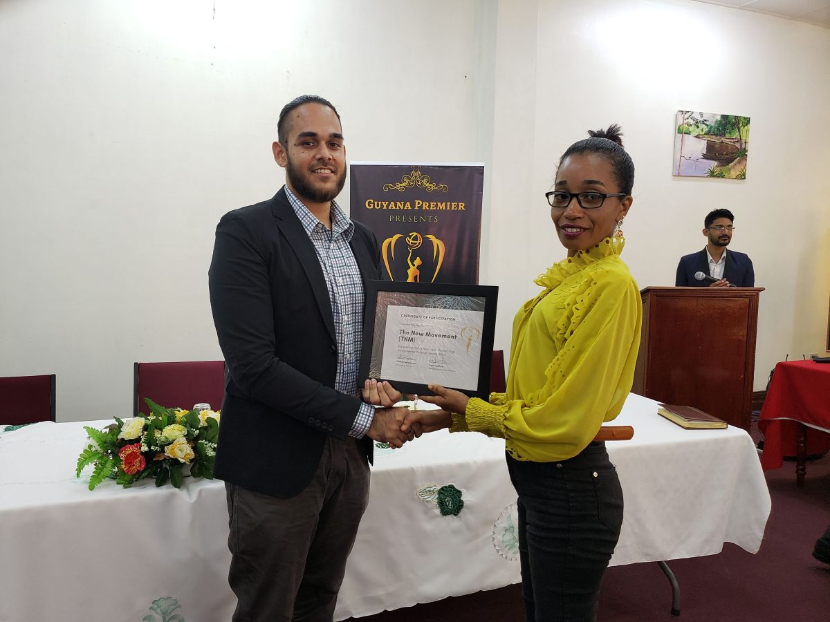 The New Movement’s Daniel Khanhai (left) being presented with a certificate after the discussion.