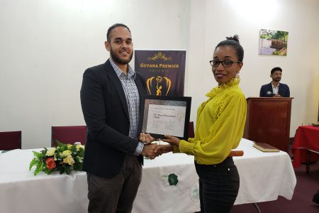 The New Movement’s Daniel Khanhai (left) being presented with a certificate after the discussion.