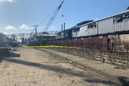 The crane that left a gaping hole in the building with visible damage to a large section of the roof (Shaquawn Gill photo) 