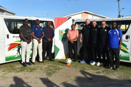 GFF President Wayne Forde [3rd from left], along with members of federation following the official presentation of the minibuses donated by UEFA through the UEFA Assist Programme.
