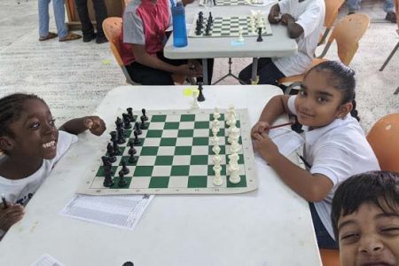 Smiling faces! Chess is a satisfying game and sometimes it is personified by the players themselves. In this photo, everyone is smiling and it depicts how happy they are feeling. At left is Tzedeq Ausar of the Colaaco School (the Centre of Learning and Afro-Centric Orientation). The school is managed by the Education Management Committee of ACDA. On the right is Katara Rodrigues of Marian Academy. The photobomber is Jacob McDonald representing the School of the Nations. The event was the Mae’s Mashramani Under-14 Development Chess Tournament which was contested last weekend.
