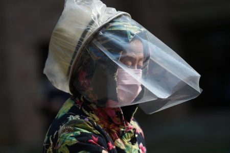 A resident wears a makeshift protective face shield at a residential compound in Wuhan, the epicentre of the novel coronavirus outbreak, Hubei province, China February 21, 2020. REUTERS/Stringer