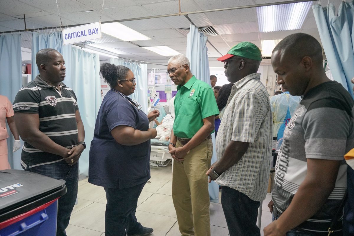 President David Granger [centre) listening yesterday to a doctor at the Georgetown Public Hospital Corporation after the injured soldiers were admitted. [Ministry of the Presidency photo)