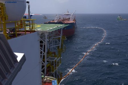 The fuel hose leads from the Liza Destiny to the Cap Philippe for the transfer of Guyana’s first million barrels of crude. (Ministry of the Presidency photo)