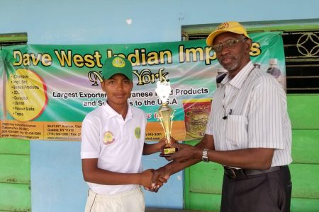 Salim Khan receives his player of the match award from match referee, Grantley Culbard.