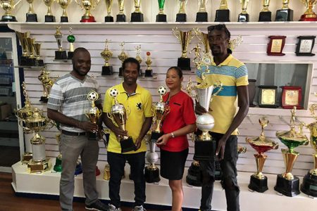 Woodpecker Trophies and Sport, representative Maria Samaroo posing alongside tournament chief Esan Griffith (left), Kingston captain Nigel Denny (2nd left) and Rio All-Stars manager Troy Lambert (right) at the official trophy presentation ceremony.
