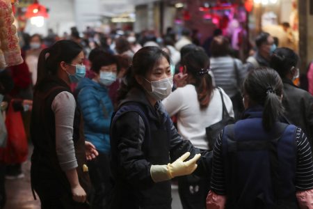 People wear protective face masks at a market in Hong Kong on Feb, 3. 