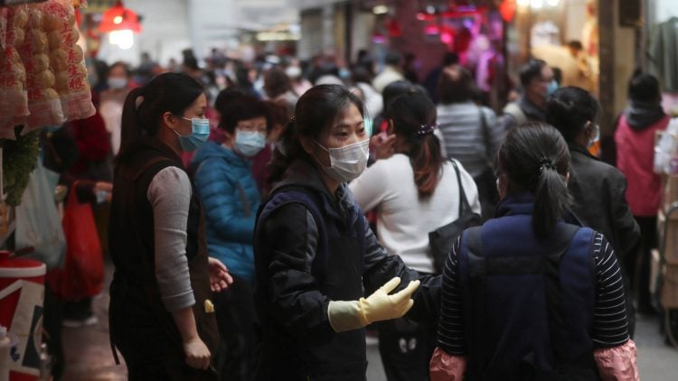 People wear protective face masks at a market in Hong Kong on Feb, 3. 