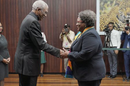 President David Granger (left) congratulates Barbados’ Prime Minister, Mia Amor Mottley after she was bestowed with the Order of Roraima at the Ministry of the Presidency yesterday. (Ministry of the Presidency photo)