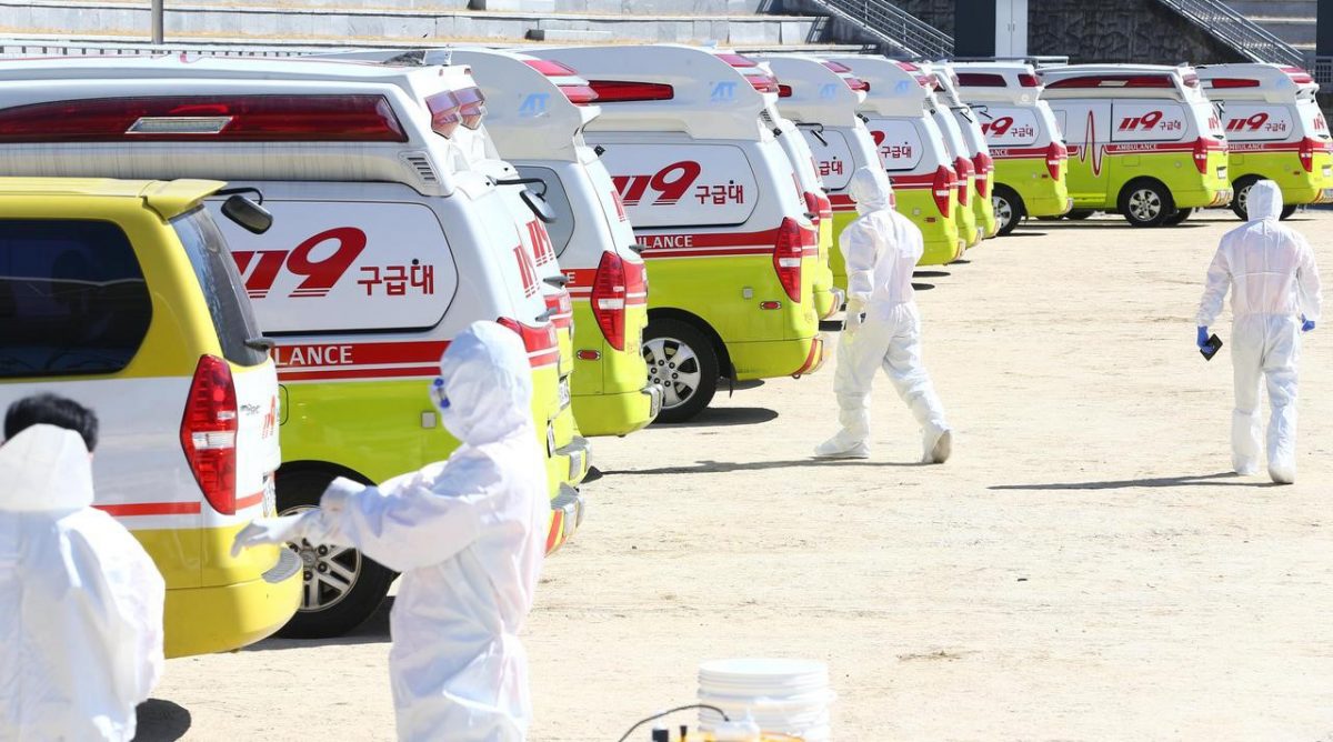 Medical workers get ready as ambulances are parked to transport a confirmed coronavirus patient in Daegu, South Korea, February 23, 2020. Yonhap via REUTERS
