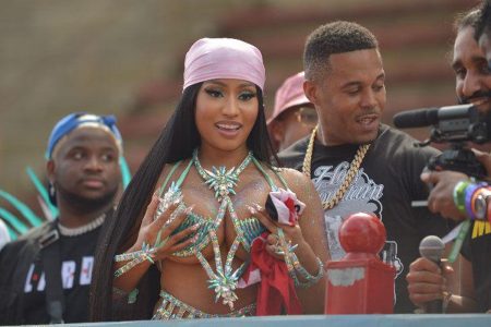 Soca in 2021?: Trinidad-born American rapper Nicki Minaj and her husband, Kenneth Petty, centre, view the Parade of the Bands yesterday from atop a music truck at the Socadrome, Jean Pierre Complex, Port of Spain
