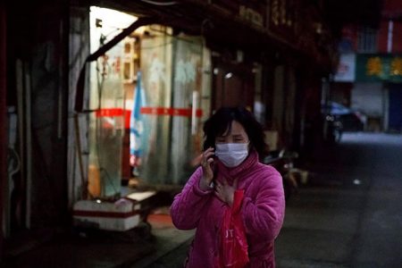 A woman wears a face mask in a market alley in Jiujiang, Jiangxi province, China, as the country is hit by an outbreak of a new coronavirus, February 1, 2020. REUTERS/Thomas Peter
