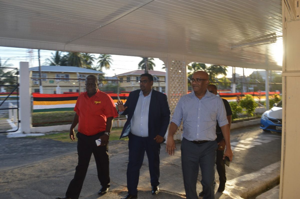 PPP presidential candidate Irfaan Ali (cemtre) flanked by Opposition Leader Bharrat Jagdeo (right) and prime ministerial candidate Mark Phillips on their way to the meeting. (PPP photo)