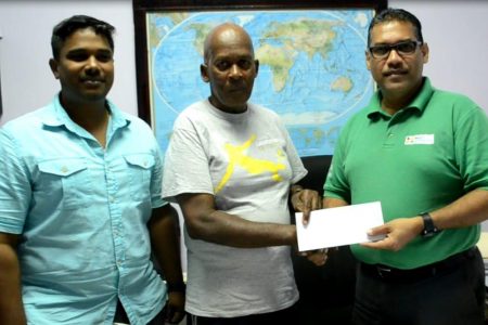 Flying Ace’s Randolph Roberts (center) receives the sponsorship cheque from Senior Branch Manager, Wazim Ali in the presence of Assistant Sales Manager, Sasenarine Makaci.
