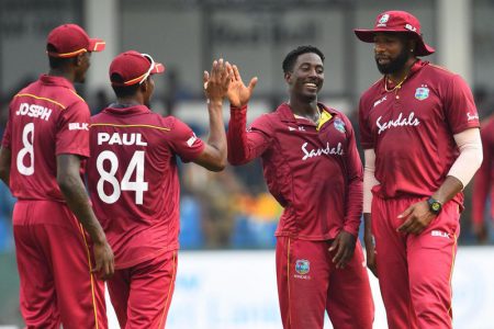 West Indies players Alzarri Joseph, Keemo Paul, Hayden Walsh Jr., and Kieron Pollard celebrate the fall of a Sri Lanka batsman’s wicket during the first ODI on Saturday. (Photo courtesy Cricket West Indies)
