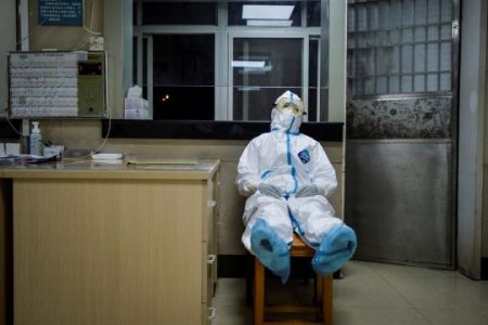A medical worker in a protective suit taking a break (Reuters photo)