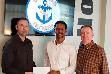 YBG Co-Director Rayad Boyce [center] receives the sponsorship cheque from Daniel LaFont [left], the Business Development Director. Also in the photo is Country Manager Cory Jarreau.
