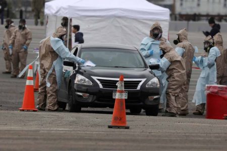 Members of the Colorado Air National Guard test people who suspect they are infected with coronavirus at a drive-thru testing station in Denver, Colorado yesterday. (Reuters photo)
