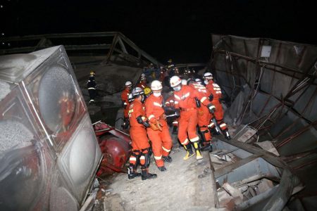Rescue workers move a casualty on the site where a hotel being used for the coronavirus quarantine collapsed in the southeast Chinese port city of Quanzhou, Fujian province, China yesterday. (Reuters photo)
