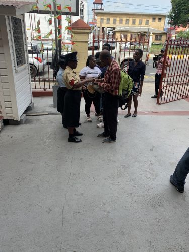 Members of the public being sanitised at the gate of the courts complex
