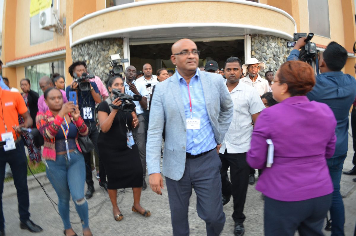 PPP General Secretary Bharrat Jagdeo (right) leaving the Returning Officer’s office at High and Hadfield streets yesterday after the spreadsheet matter was resolved