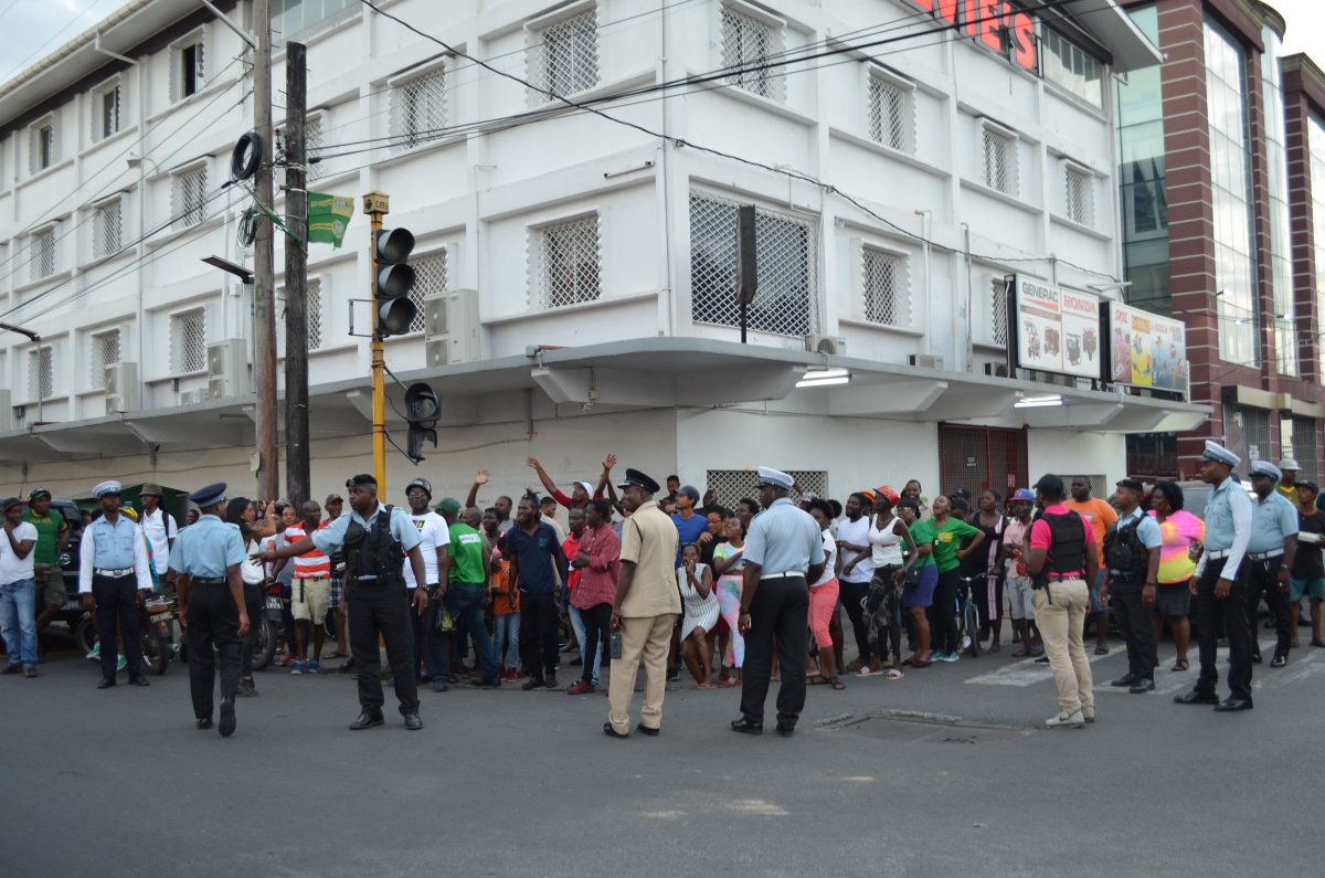 Supporters from APNU+AFC outside of the Region Four returning officer’s office yesterday afternoon during the controversy