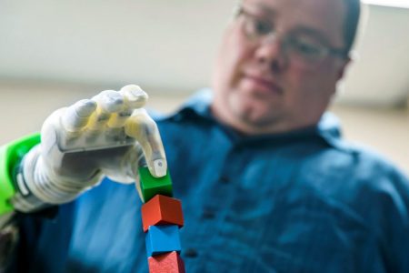 Joe Hamilton intuitively controls a DEKA prosthetic hand, made by Mobius Bionics and called the “Luke Arm,” for an advanced prosthetics study involving the Regenerative Peripheral Nerve Interface in a lab on the University of Michigan Medical Campus in Ann Arbor Michigan on August 9, 2018. (Evan Dougherty/University of Michigan Engineering photo via REUTERS) 