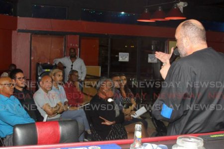 Gay rights activist Jason Jones, (right), speaks to invited guests at the launch of LGBTQ+ survey for TT at 4Play bar and lounge, St James on Friday. (Trinidad Newsday photo) 