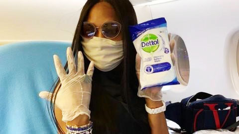 Naomi Campbell during one of her pre-flights sanitising routines.