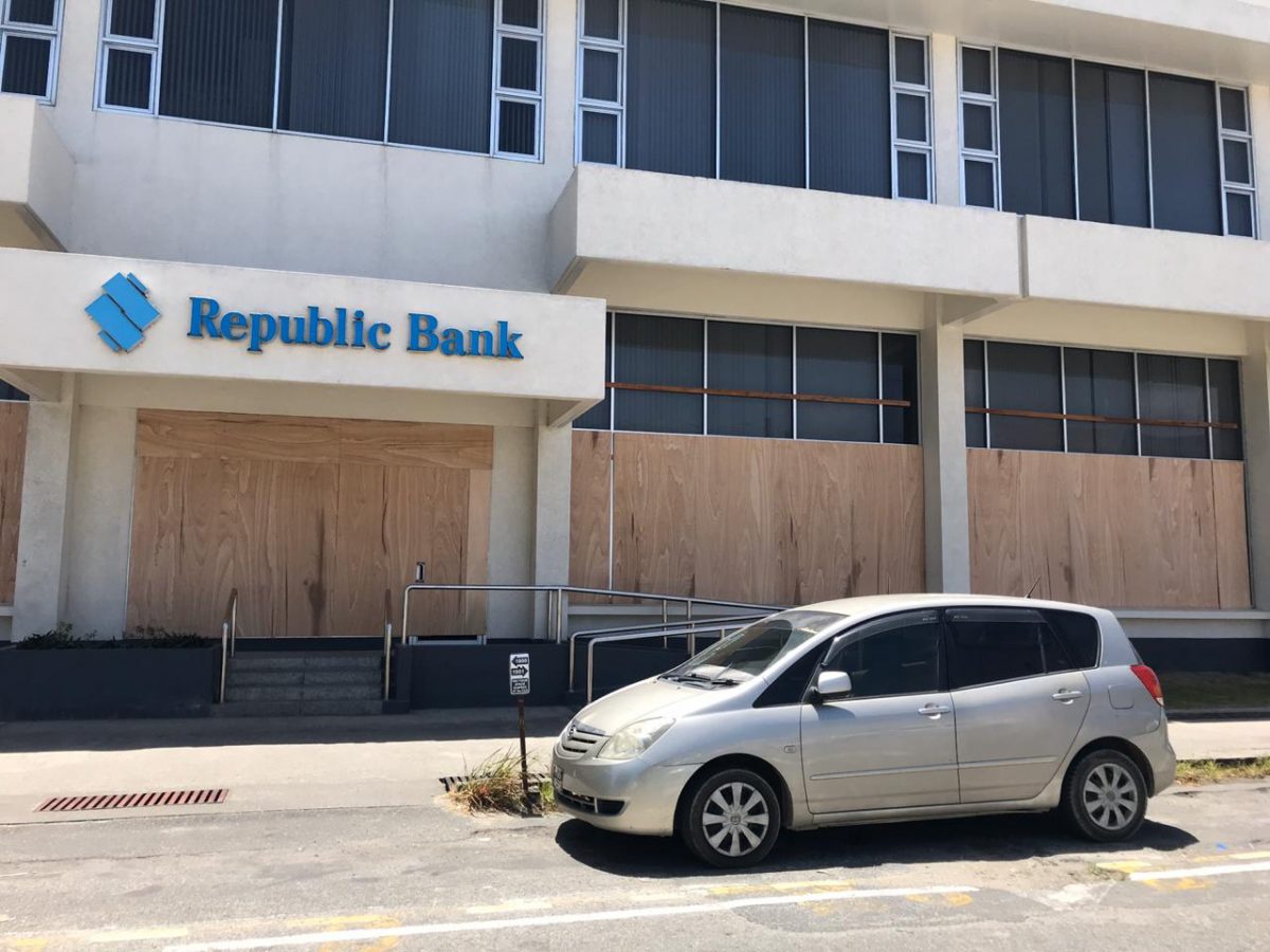 Plyboard was on Friday placed over the windows of Republic Bank’s Camp Street branch amidst unrest in several areas across the country that erupted from protests over disputed elections results