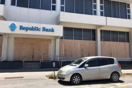 Plyboard was on Friday placed over the windows of Republic Bank’s Camp Street branch amidst unrest in several areas across the country that erupted from protests over disputed elections results