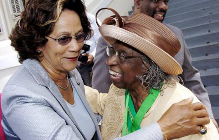 Marigold Harding (left) has a congratulatory word for the Rev Dr Carmen Stewart, then custos of St Andrew, after she was inducted into the Order of Jamaica in 2007.