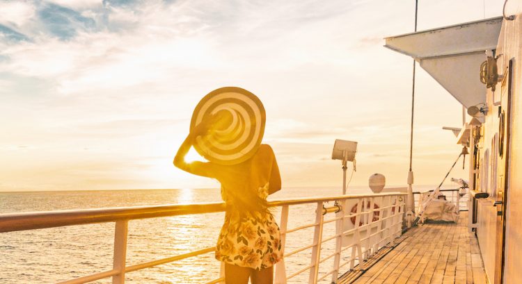 Cruise summer vacation woman watching sunset on deck banner panorama - Caribbean tropical landscape travel lifestyle.