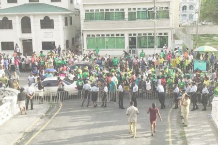 Supporters of  APNU+AFC congregated on Croal Street behind the police line as the court heard arguments from both sides on a suit seeking full verification of the vote for Region Four at last week’s general and regional elections. 