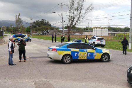 A police vehicle is seen at the entrance to the Golden Grove Prison in Arouca, which is currently lock down in attempts to stop prisoners from escaping, as they  claim they are fearful of contracting the COVID-19 coronavirus. -Photo: JERMAINE CRUICKSHANK 
