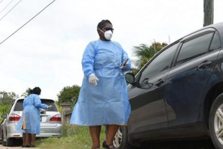 The Health Ministry officials carrying out contact tracing in Corn Piece, Clarendon today - Gladstone Taylor photo