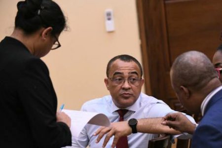 Health Minister Dr Christopher Tufton consults with Chief Medical Officer Dr Jacquiline Bisasor McKenzie and Permanent Secretary Dunstan Bryan before the press conference - Ricardo Makyn photo.