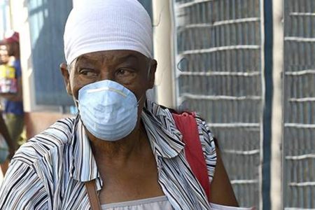 A woman, spotted in downtown Kingston, yesterday, wears gloves and a face mask as she seeks to protect herself from the novel coronavirus.