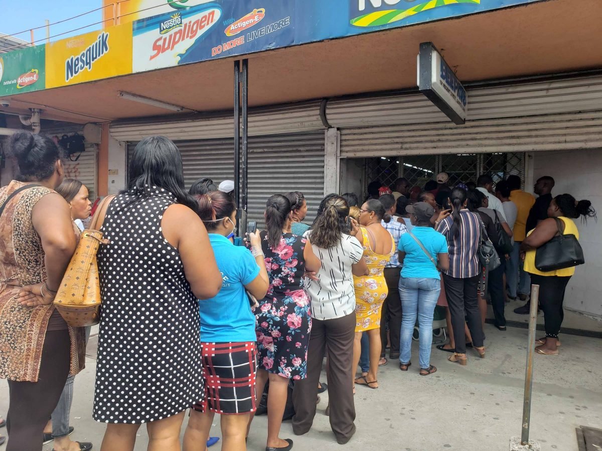 Persons waiting their turn to enter the Beepats Supermarket on Regent Street last Thursday