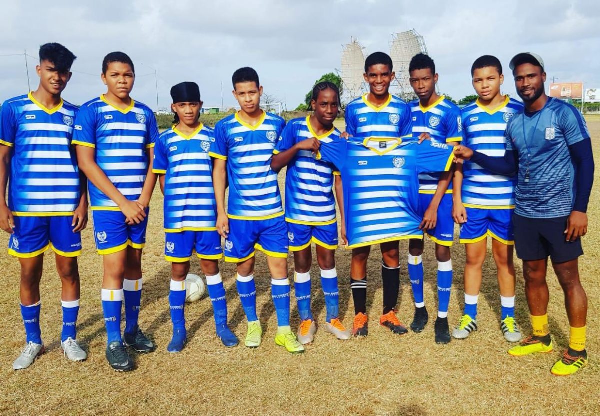 Vurlon Mills (right), alongside members of the VMFA, displaying the newly purchased Squadra Kits prior to the commencement of a training session.
