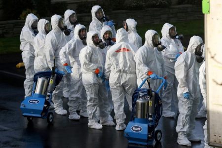Members of a Servpro cleanup crew wearing hazardous material suits prepare to enter Life Care Center of Kirkland, the Seattle-area nursing home at the epicenter of one of the biggest coronavirus outbreaks in the United States, in Kirkland, Washington, U.S. March 11, 2020. REUTERS/Jason Redmond/File Photo