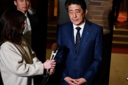 Japan’s Prime Minister Shinzo Abe talks to journalists in front of the Prime Minister’s residence in Tokyo Japan, yesterday after a phone call with IOC President Thomas Bach on postponing the Olympic Games. (Reuters photo).