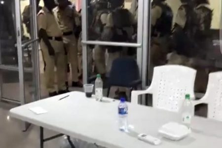 A still image from the video showing the ranks about to enter the Tabulation centre to remove party agents.
