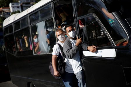 A crowded bus with people using protective masks passes through a checkpoint after the start of quarantine in response to the spreading of coronavirus disease (COVID-19) in Caracas, Venezuela, March 16, 2020. REUTERS/Manaure Quintero
