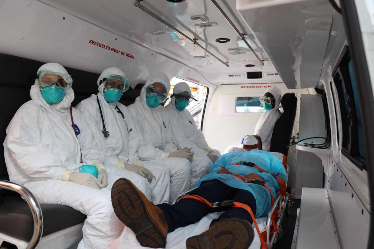 SIMULATION: This photo, taken in early February, shows preparations by health authorities to transport an arriving passenger suspected of having the COVID-19.