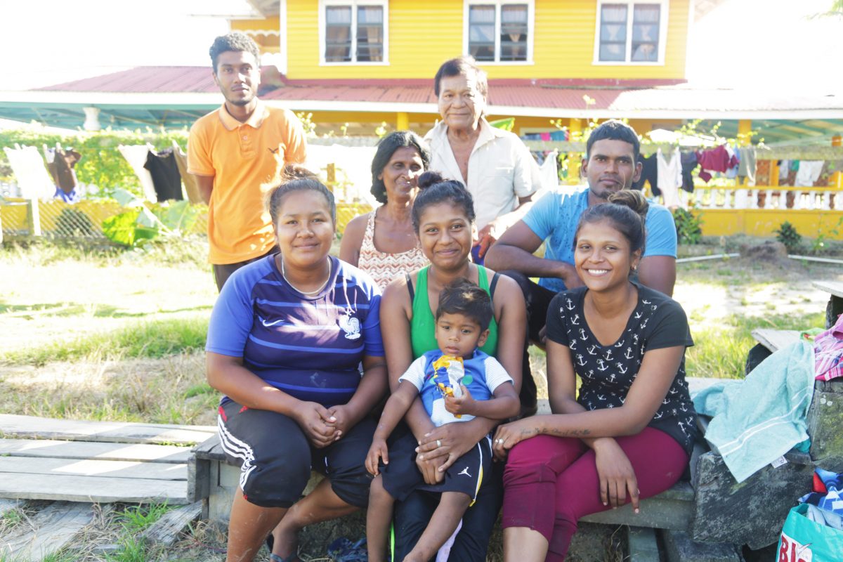 Amina Alberts [centre, forefront) holds her son in her lap. She is surrounded by her relatives. 